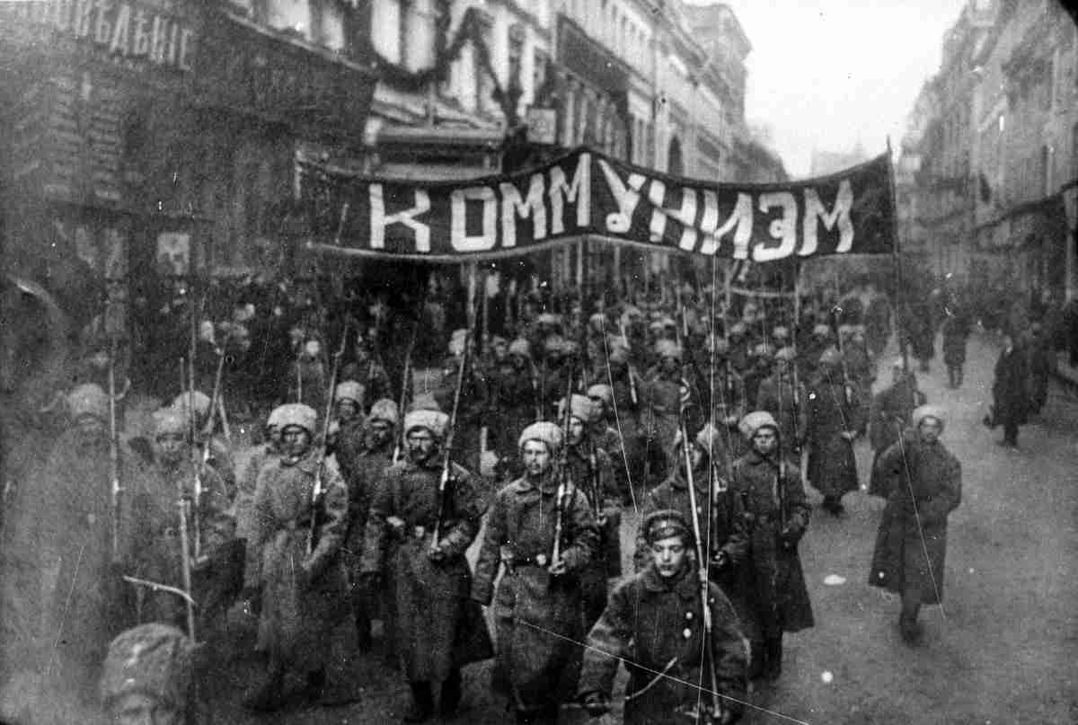 2812 Armed soldiers carry a banner reading Communism Nikolskaya street Moscow October 1917 sw - Kapitalismus, Krieg und beider Überwindung - UZ vom 15. Juli 2022 - UZ vom 15. Juli 2022